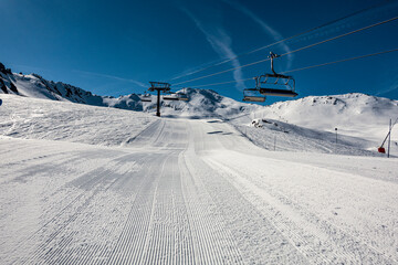 Ski Piste with tracks and blue sky, Austria