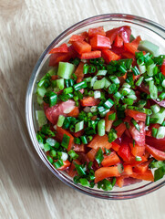 Fresh summer salad in the glass bowl.