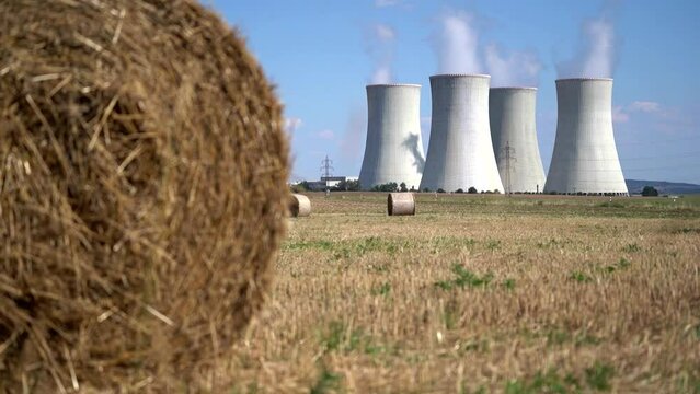 Cooling towers at nuclear power plant, energy self-sufficiency, greenhouse emission reduction and global warming concept