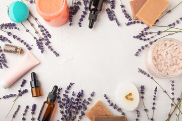 SPA. Lavender flowers, scented candle, body cream, essential oil, scrub and handmade soap. Natural herbal cosmetics with lavender flowers on a white texture background.FLET LAY © Avocado_studio