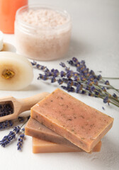 SPA. Lavender flowers, scrub and handmade soap. Natural herbal cosmetics with lavender flowers on a white texture background.FLET LAY © Avocado_studio