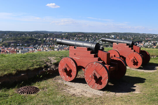 Two historic canons pointed towards Halden city from Fredriksten Fortress in Viken, Norway. Copy space above.