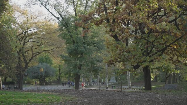 Manhattan, New York City, USA - October 29 2022: Central Park Fall Foliage - People Walking, Biking and Jogging in the Morning
