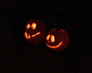 Jack-o-lantern faces with candle light at night