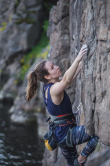A girl climbs a rock