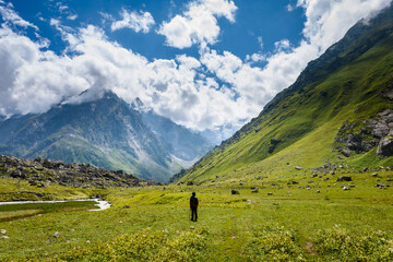 Man hiking on beautiful Pin bhabha pass trail in Himalayas mountains with backpack. Travel Lifestyle wanderlust concept
