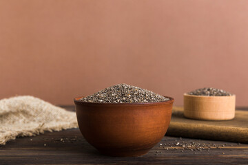 Chia seeds in bowl on colored background. Healthy Salvia hispanica in small bowl. Healthy superfood