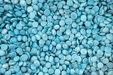 Full frame of Blue Turquoise glass gemstone particles. Decorative Stone pebbles for coating in the Aquarium or garden. Extreme close up of heap, top view