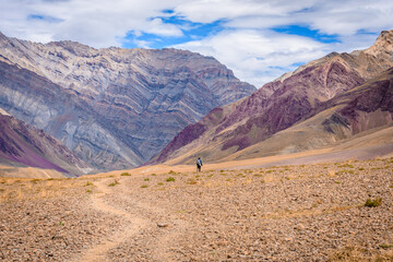 Man hiking on beautiful Pin bhabha pass trail crossing through spiti valley in Himalayas mountains with backpack. Travel Lifestyle wanderlust concept	