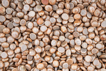 Full frame of brown glass gemstone particles. Decorative Stone pebbles for coating in the Aquarium or garden. Extreme close up of heap, top view