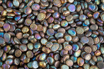 Full frame of colorful glass gemstone particles. Decorative Stone pebbles for coating in the Aquarium or garden. Extreme close up of heap, top view