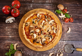 Pizza funghi with tomato sauce, mozzarella and fresh mushrooms top view
