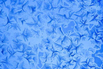 Frost patterns on window glass in winter