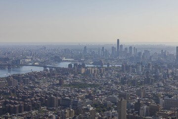 Fototapeta premium Beautiful view of in fog Manhattan's skyscrapers on cityscape background. New York. USA.