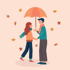 Happy autumn couple walking with umbrella.