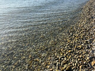 sea pebbles, transparent sea water with rocky bottom