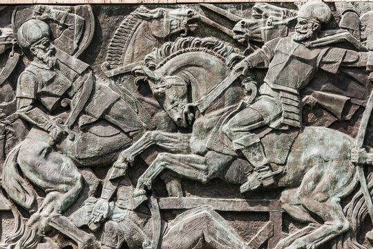 Cluj-Napoca, Romania - JUN 17, 2021: Wall sculpture showing one of the battles of Michael The Brave (Mihai Viteazu), a Romanian historic hero, against ottoman empire