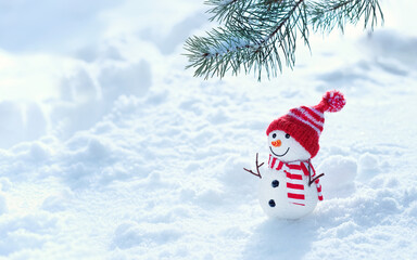 snowman and pine tree branch in snow, natural winter background. New Year and Christmas holiday....