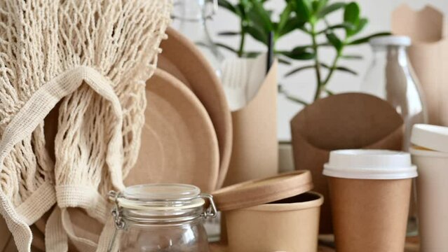Eco-friendly paper packaging and disposable tableware. Selective focus on the dishes at the end of the camera movement.