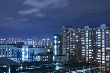 cityscape view at night from a window with blue lights