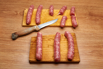 pork sausages on cutting boards and serrated knife