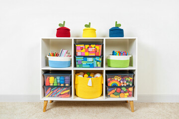 White shelving with rainbow wooden toys and colorful storage baskets and boxs. Interior design....