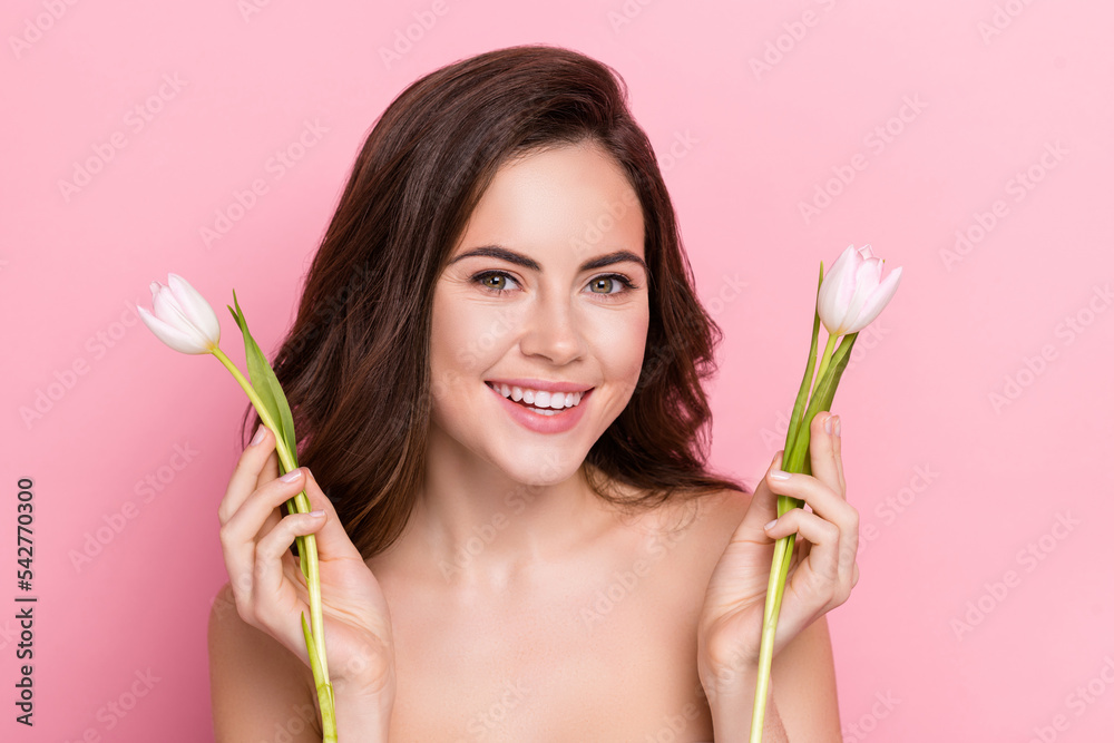 Poster portrait of attractive cheery girl holding in hands white tulips isolated over pink pastel color bac