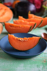 sliced organic melon on blue plate - closeup