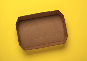 recyclable paper tray on yellow background - isolated - closeup