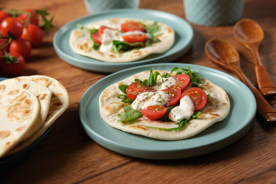 azimo bread with tomato, mozzarella and arugula - closeup