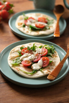 azimo bread with tomato, mozzarella and arugula - closeup