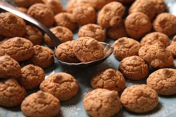 pile of cookie amaretti with spoon - traditional Italian pastry - closeup
