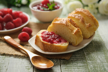 raspberry jam in the slice of bread - closeup