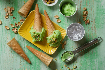 homemade pistachio ice cream on green wooden table - closeup