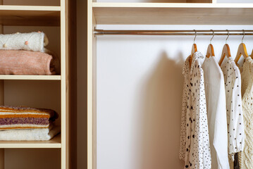 Big wardrobe with different clothes and accessories in dressing room