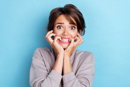 Photo of impressed lady negative news accident bite fingernails creepy spooky halloween party isolated on blue color background