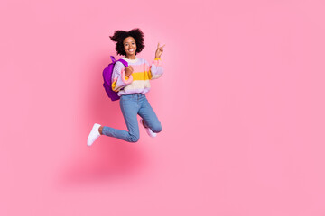 Fototapeta na wymiar Full length photo of pretty shiny small kid wear striped sweater jumping high showing v-sign empty space isolated pink color background