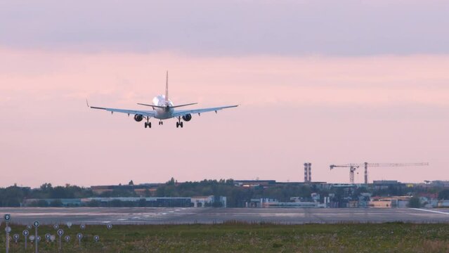 Jumbo Jet Airplane Plane Landing In Chopin Airport In Warsaw airport at dusk
