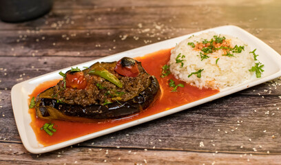 Karniyarik turkish hollowed aubergine stuffed with minced meat, served with rice