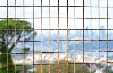 Obraz premium City view between rusty iron mesh bars istanbul behind