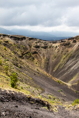 The crater of the Paricutin volcano with some smoke.