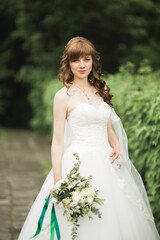 Fototapeta na wymiar Beautiful luxury bride in elegant white dress