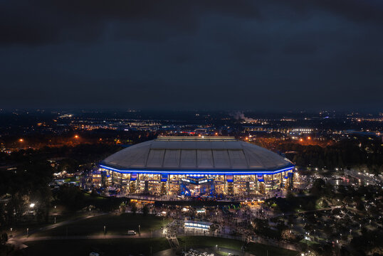 Arial panoramic night view on the illuminated Veltins Arena (Arena AufSchalke), home stadium for Bundesliga team FC Schalke 04. Gelsenkirchen, Ruhr, Germany - October 2022