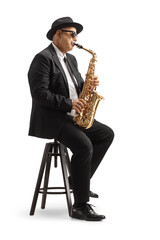 Mature man playing a sax and sitting on a chair