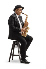 Naklejka premium Mature man playing a sax and sitting on a chair