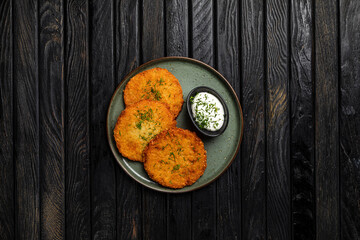 Potato pancakes with sour cream sauce garnished with dill
