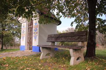 A little folklore decorated chapel with seat around near Straznice, Czech republic
