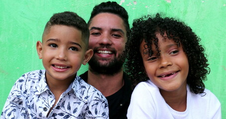 Hispanic father with children, latin kids with parent smiling, real people