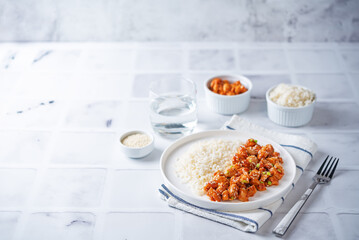Sweet and sour chili sauce chicken with rice in a plate