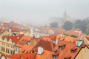 Fototapeta premium Cityscape on a foggy morning - view of Mala Strana historical neighbourhood of Prague, Czech Republic
